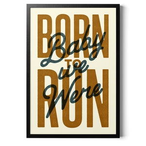 May include: A framed print with the text "Born to Run" in a vintage style font. The text is in a dark blue color with a brown background.