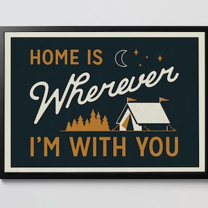 May include: A dark blue poster with white text that reads "Home is Wherever I'm With You". The poster features a white tent with orange flags, a crescent moon, and stars. There are also orange trees in the background.