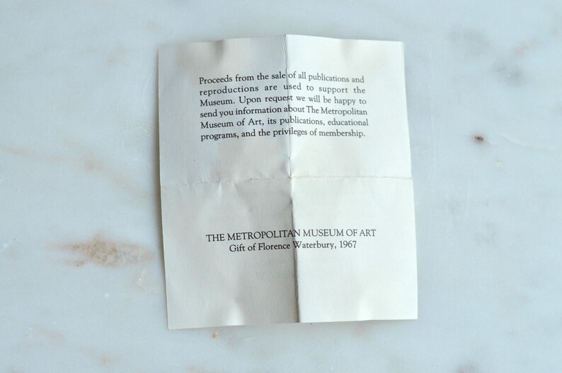May include: A folded, off-white paper with printed text from The Metropolitan Museum of Art. The text includes information about publications, educational programs, and membership privileges. The paper is a gift from Florence Waterbury, 1967.