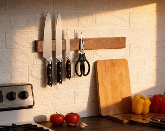 May include: A kitchen scene featuring a wooden knife holder with several knives and scissors. A wooden cutting board and fresh produce, including tomatoes and bell peppers, are also visible. The knives have black handles.