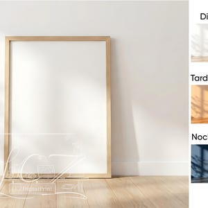 Puede incluir: Un marco de fotos grande, rectangular y en blanco con un acabado de madera clara se apoya contra una pared blanca. El marco está vacío, ofreciendo espacio para una impresión o una obra de arte personalizada. La imagen está bien iluminada, con sombras.