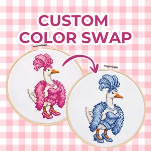 May include: Two circular wooden embroidery hoops containing cross-stitch designs of a goose wearing a feathered boa, a headpiece, and high heels. The left goose is pink, and the right goose is blue. Text reads CUSTOM COLOR SWAP.