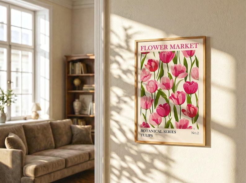 May include: A framed botanical print featuring a vibrant display of pink tulips against a cream background. The print is labeled "Flower Market" and "Botanical Series Tulips No. 2". The artwork is displayed on a beige wall in a well-lit room.