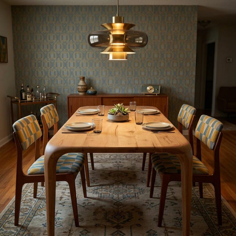 May include: A dining room featuring a wooden table and six chairs with patterned upholstery. A brass and glass light fixture hangs above the table, which is set with plates and glasses. The room also includes a rug and a sideboard, creating a mid-century modern aesthetic.