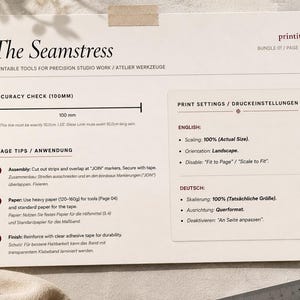 May include: Printable tools for precision studio work, titled "The Seamstress." The document includes accuracy check with a 100mm line, usage tips, and print settings in English and German. A measuring tape and ruler are visible.