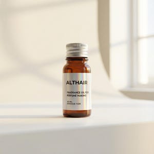 May include: A small amber glass bottle with a silver cap. The label reads "ALTHAIR FRAGRANCE OIL FOR PERFUME MAKING 10 ML DOSAGE %20". The bottle is sitting on a white surface.