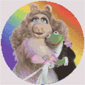 May include: A cross-stitch of Miss Piggy and Kermit the Frog embracing, set against a rainbow gradient background. Miss Piggy wears a light pink dress, while Kermit is in a black tuxedo. The artwork is circular.