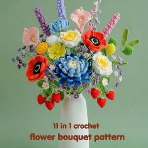 May include: A handmade crochet flower bouquet in a white vase. The bouquet features a variety of colorful flowers, including red poppies, blue chrysanthemums, and pink calla lilies, with red crochet strawberries. The text on the image says "11 in 1 crochet flower bouquet pattern".