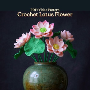 May include: A crochet lotus flower arrangement featuring pink and white petals with yellow and green centers, accompanied by green leaves on thin stems. The text PDF+Video Pattern Crochet Lotus Flower is displayed above the flowers.