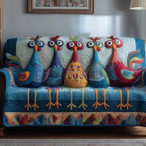 May include: A sofa with five decorative rooster cushions. The cushions are in various colours, including blue, red, and yellow, and are arranged on a quilted sofa cover. The sofa cover features a rooster-themed design.