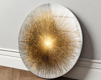 May include: A circular wall art piece with a striking golden burst design. The artwork features a central, bright light source with radiating lines and small, sparkling details, creating a dynamic visual effect. The piece is set against a white background.