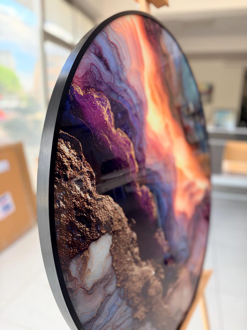 Angled detail of circular wall decor, flowing purple, copper and gray marble patterns, bold gold vein abstract marble wall art