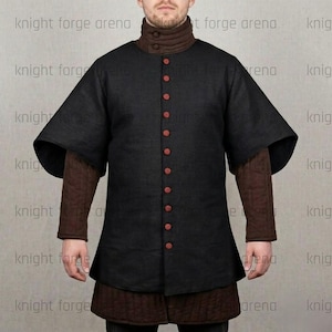 May include: Black medieval gambeson with red buttons and short sleeves. The garment has a high collar and is worn over a brown undergarment. The text "knight forge arena" is visible on the image.