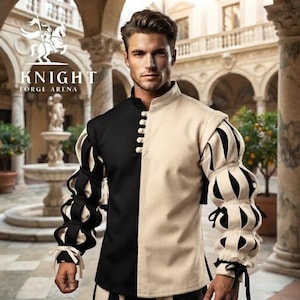Peut inclure: Un pourpoint &agrave; manches longues pr&eacute;sentant un design bicolore noir et beige, un col montant et une rang&eacute;e verticale de boutons. Les manches sont dot&eacute;es d'un motif bouffant et lac&eacute;r&eacute; r&eacute;v&eacute;lant un tissu noir en dessous, avec des liens aux poignets.