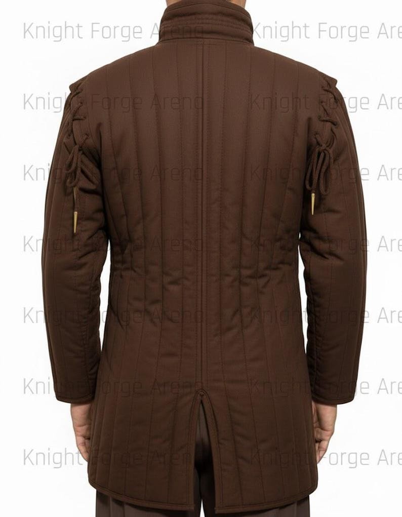 May include: Brown padded jacket with vertical stitching and long sleeves. Features decorative ties on the shoulders and sleeves. The jacket has a high collar and a split at the back. The text "Knight Forge Arena" is visible.