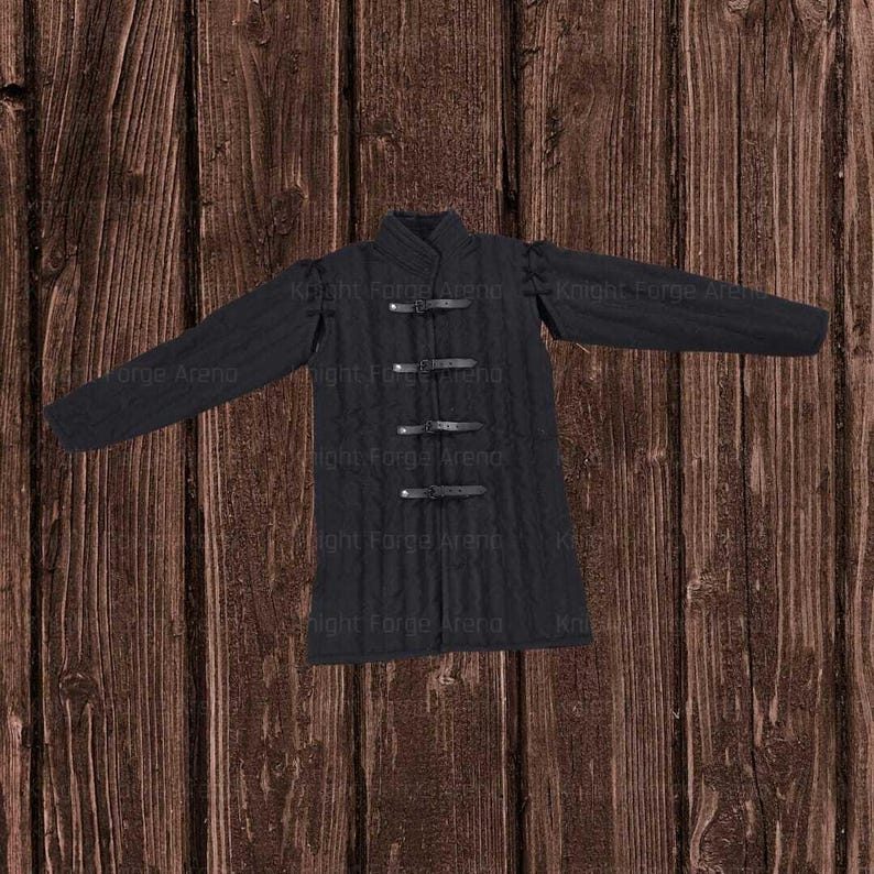 May include: Black quilted gambeson with long sleeves and three leather straps. The text "Knight Forge Arena" is visible. This medieval garment is designed for historical reenactment or costume use.