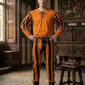 May include: An orange and black striped Renaissance costume. The long-sleeved shirt has black striped sleeves and a laced neckline. The matching pants are vertically striped. The outfit is completed with a brown belt and black boots. The text "knight forge arena" is visible.