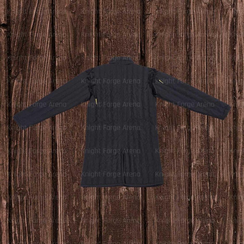 May include: A black quilted gambeson, a padded garment worn under armor. The long-sleeved jacket has a high collar and a buttoned front. The text "Knight Forge Arena" is visible on the garment.