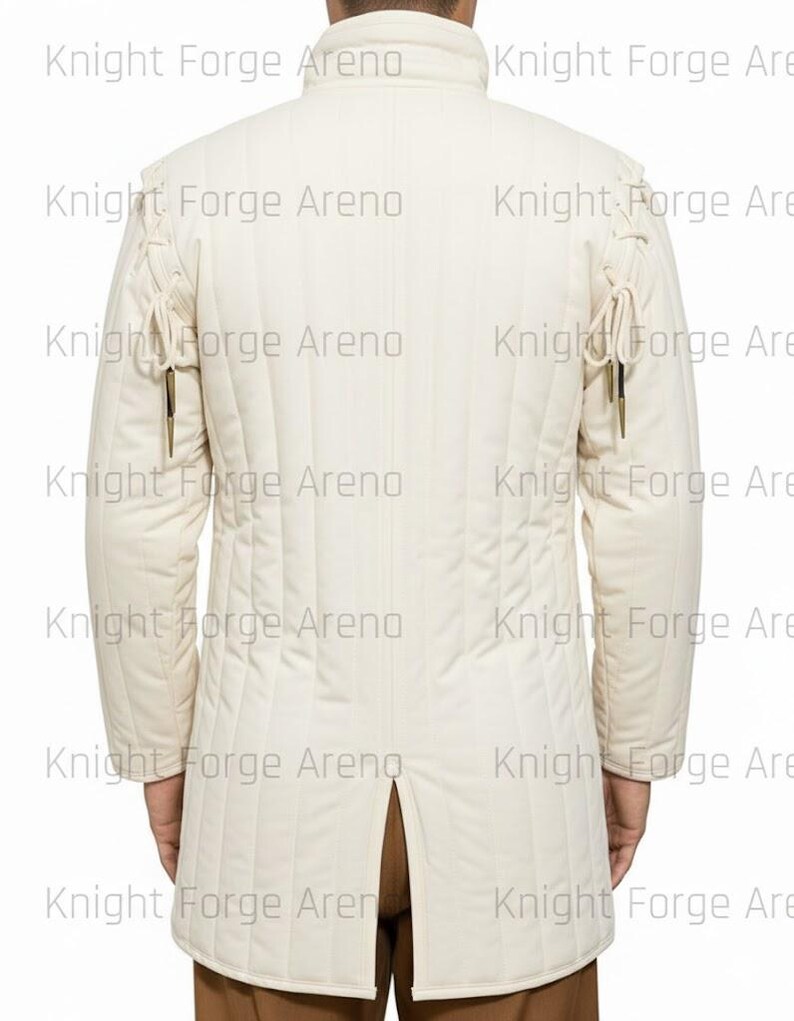 May include: Cream-colored, quilted jacket with a high collar and long sleeves. The jacket features vertical stitching and decorative ties on the shoulders and sleeves. The back of the jacket has a split at the hem. The text "Knight Forge Arena" is watermarked across the image.