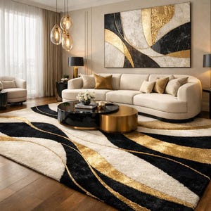 May include: A rectangular area rug featuring a flowing, abstract pattern in black, cream, and metallic gold. The design consists of sweeping, curved lines and textured sections that create a sense of movement across the floor surface.