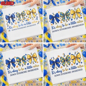 May include: White t-shirt with blue and yellow bow designs, ribbons, and text that reads "It's okay to be a little extra" and "Down Syndrome Awareness". The shirt is held by hands and surrounded by blue and yellow decorations.