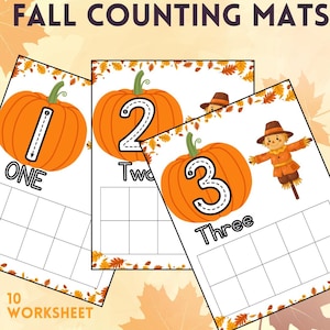 May include: Three educational counting mats titled FALL COUNTING MATS, each featuring a large orange pumpkin with a number one, two, or three, the written word, and a ten-frame grid. The third mat includes a small scarecrow illustration.