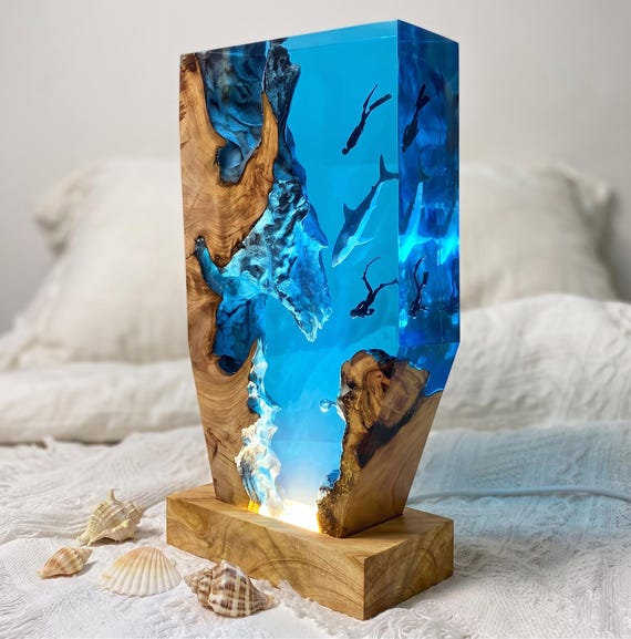 A miniature deep-sea world frozen in glowing resin — whale shark, scuba diver, and RGB color-shifting light all in one sculptural lamp.