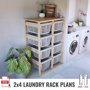 May include: A wooden laundry rack with eight white plastic baskets. The rack has a light brown top and a natural wood frame. The text "2x4 LAUNDRY RACK PLANS" is at the bottom of the image. The image also includes a plant in a gray pot.
