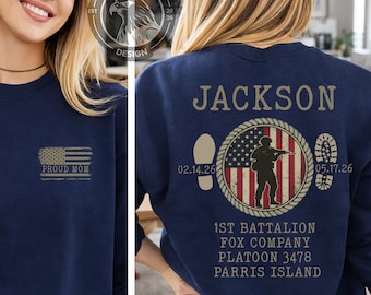 May include: Navy blue sweatshirt with "PROUD MOM" and an American flag graphic on the front. The back features the name "JACKSON", a soldier silhouette, dates, and military unit details. A patriotic themed apparel item.