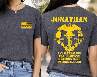 May include: Dark gray t-shirt with a yellow American flag and the words "PROUD MOM" on the front. The back of the shirt features the name "JONATHAN", an eagle, anchor, dates, and text about the 1st Battalion Fox Company.