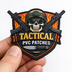 May include: A black and orange PVC patch with a skull wearing a helmet and sunglasses, crossed rifles, and a knife. The text "TACTICAL PVC PATCHES" is in yellow and white.