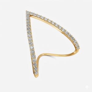 May include: A gold-colored ring with a unique, open design. The ring features a triangular shape lined with small, clear gemstones. The band curves around the finger, creating a modern and elegant look. The ring is set against a plain white background.