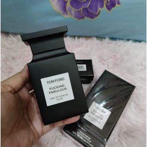May include: Black Tom Ford fragrance bottle with the text "Fucking Fabulous" on a white label. The bottle is 100 ml. A second, wrapped box with the same label is also visible.