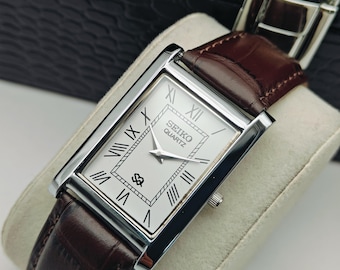 Reloj de pulsera Seiko Slim Tank vintage para hombre, de cuarzo y correa de cuero marrón.