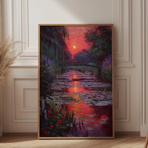 May include: A framed painting depicts a sunset over a water garden with a bridge. The artwork features vibrant red, orange, and purple hues reflecting in the water. Lush greenery and flowers surround the water, with a bright sun setting in the distance.