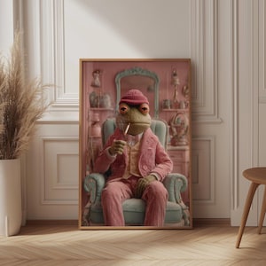 May include: A framed art print depicting a frog in a pink corduroy suit, seated in a teal armchair, smoking a cigarette. The frog is wearing a red beanie and a yellow waistcoat. The background shows a pink room with a mirror and ornaments.