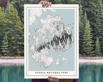 May include: A rectangular topographic map print of Acadia National Park featuring black contour lines on a light blue background. The print includes the text ACADIA NATIONAL PARK and ELEVATIONS 0' TO 1,530' printed in black at the bottom center.