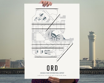 May include: A black and white map of Chicago O'Hare International Airport (ORD) with the airport code "ORD" printed in large, bold, black letters below the map. The map shows the layout of the airport terminals and runways.