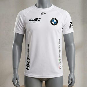 May include: A white short-sleeved t-shirt featuring the BMW logo, WEC FIA World Endurance Championship branding, and HRT Season 2026 text. The shirt also displays Le Mans Racing Simulator text with a small tricolor stripe and the number 24 on the sleeve.