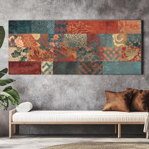 May include: A rectangular wall art piece with a patchwork design. The artwork features various rectangular panels with floral and geometric patterns in shades of red, teal, gold, and brown. The artwork is displayed above a white sofa with brown pillows.