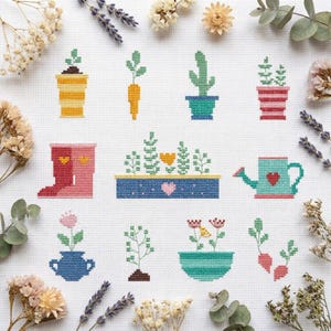 May include: A cross stitch pattern on white fabric featuring various botanical and gardening motifs including potted plants, a carrot, a cactus, pink boots with yellow hearts, a blue planter with a heart, a watering can, and flowers.