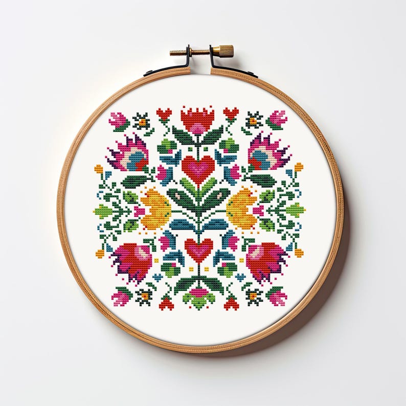 May include: A colorful cross-stitch design featuring a floral pattern with red hearts, yellow and pink flowers, and green leaves. The embroidery is set in a round wooden hoop, perfect for wall decor or a handmade gift.
