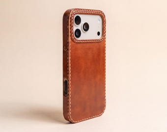 May include: A brown leather phone case featuring a smooth, matte finish and visible light-colored stitching along the edges. The case includes a rectangular cutout for the camera module, which reveals three circular lenses and a flash component.