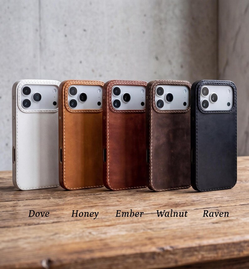 May include: Five smartphone cases arranged in a row, featuring colors labeled as Dove, Honey, Ember, Walnut, and Raven. Each case has a rectangular cutout for the camera module and visible stitching along the edges of the protective cover.