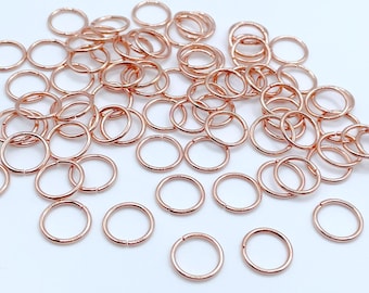 May include: A large quantity of rose gold jump rings. The jump rings are small and circular, perfect for jewelry making.