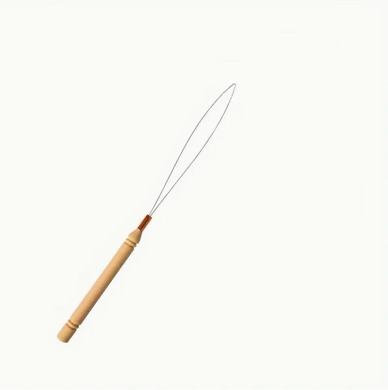 May include: A wooden hair extension tool with a thin metal loop. The handle is light brown with a copper-colored connector. The tool is designed for applying hair extensions.