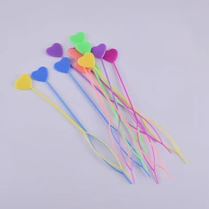 May include: A set of ten colorful heart-shaped yarn needles. The needles are made of plastic and come in a variety of colors, including pink, blue, yellow, green, and orange.