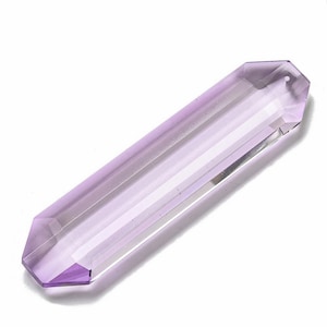 May include: A faceted, double-terminated amethyst crystal wand. The crystal is a pale lavender color with a polished, geometric shape. The wand is approximately 4 inches long.