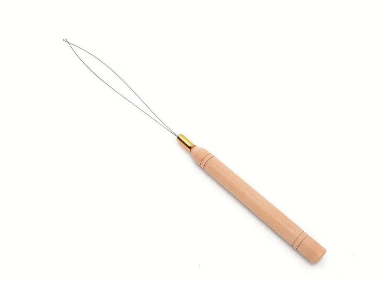 May include: A hair extension tool with a light wooden handle and a thin metal loop. The handle has a gold-colored metal ferrule and is approximately 4 inches long.