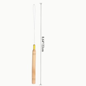 May include: A wooden hair extension tool with a gold-colored metal tip and a white string. The tool is 8.64 inches (22 cm) long. The wooden handle has a natural wood grain finish.